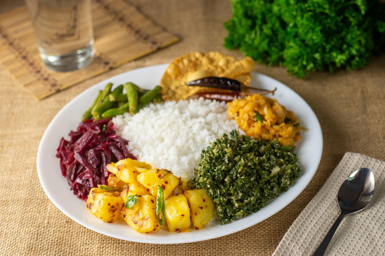 A delicious and vibrant Sri Lankan rice and curry platter with multiple small dishes.